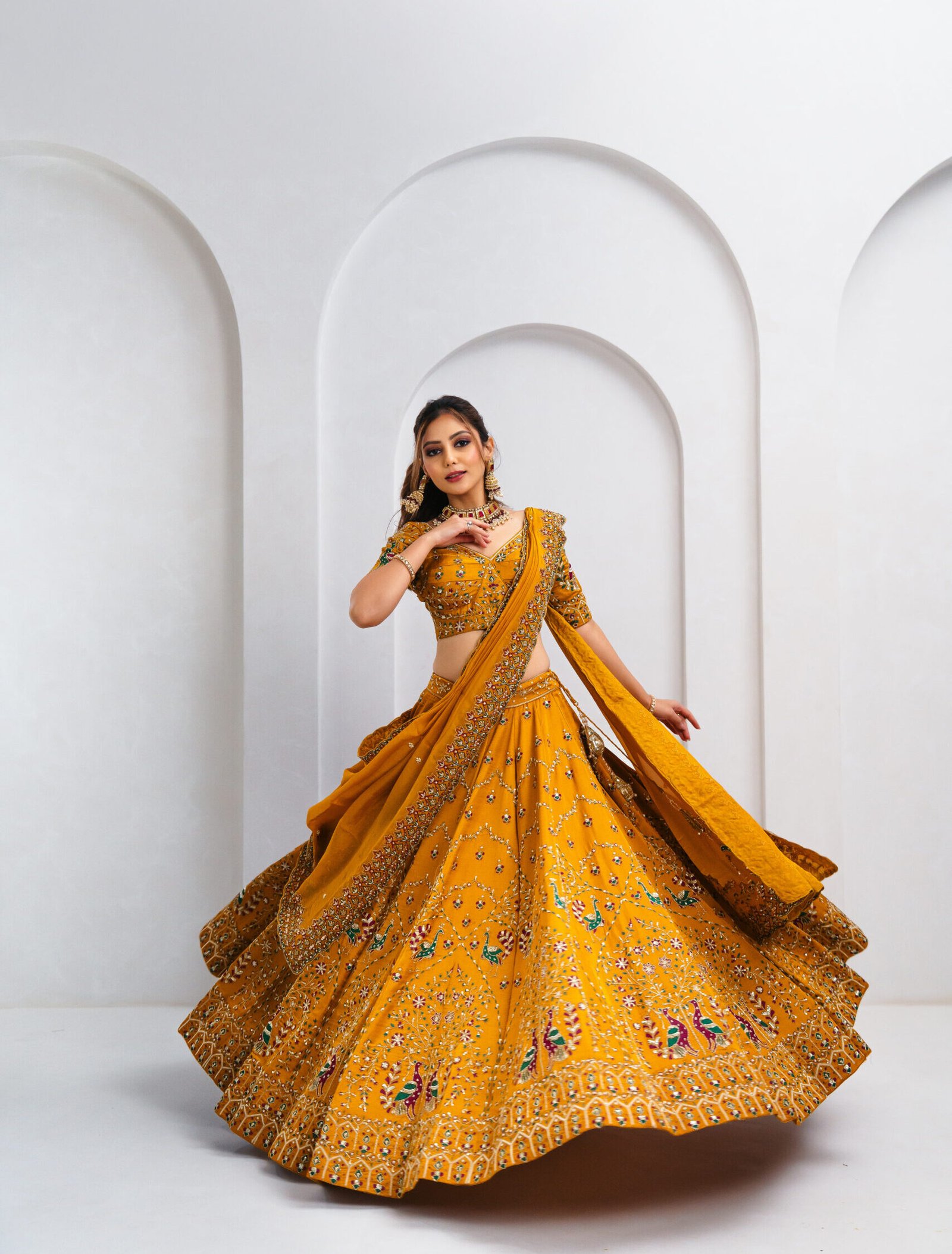Mustard yellow bridal lehenga choli with gold zari, resham, and mirror embroidery