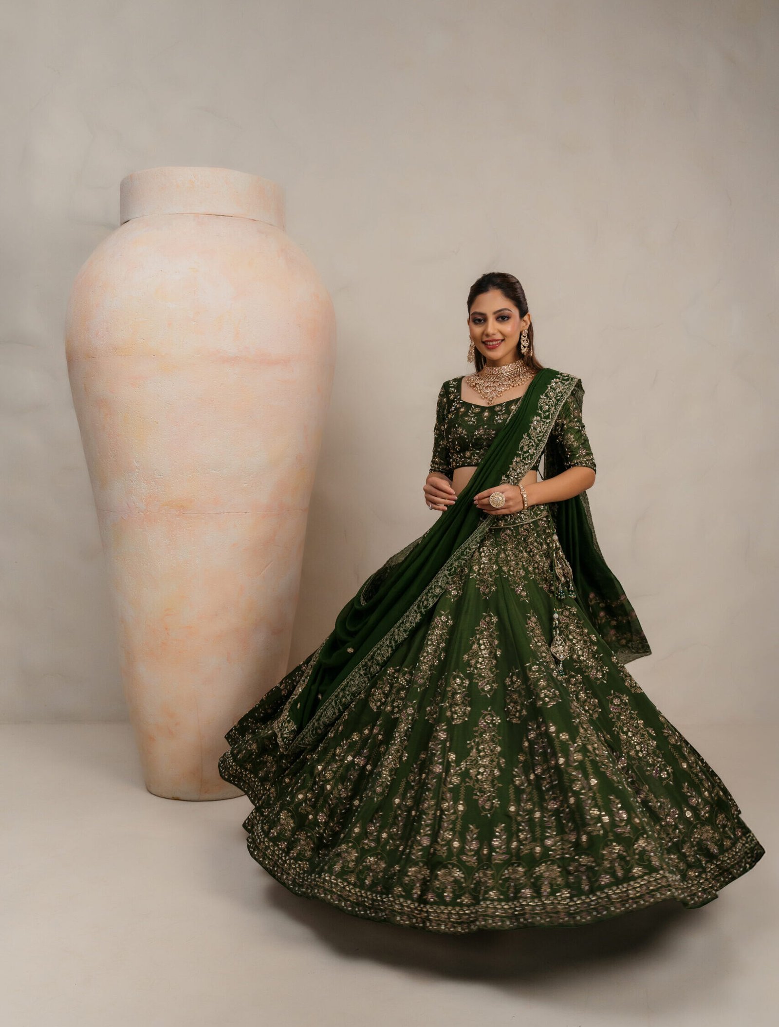 Dark green bridal lehenga choli with gold zari and sequin embroidery