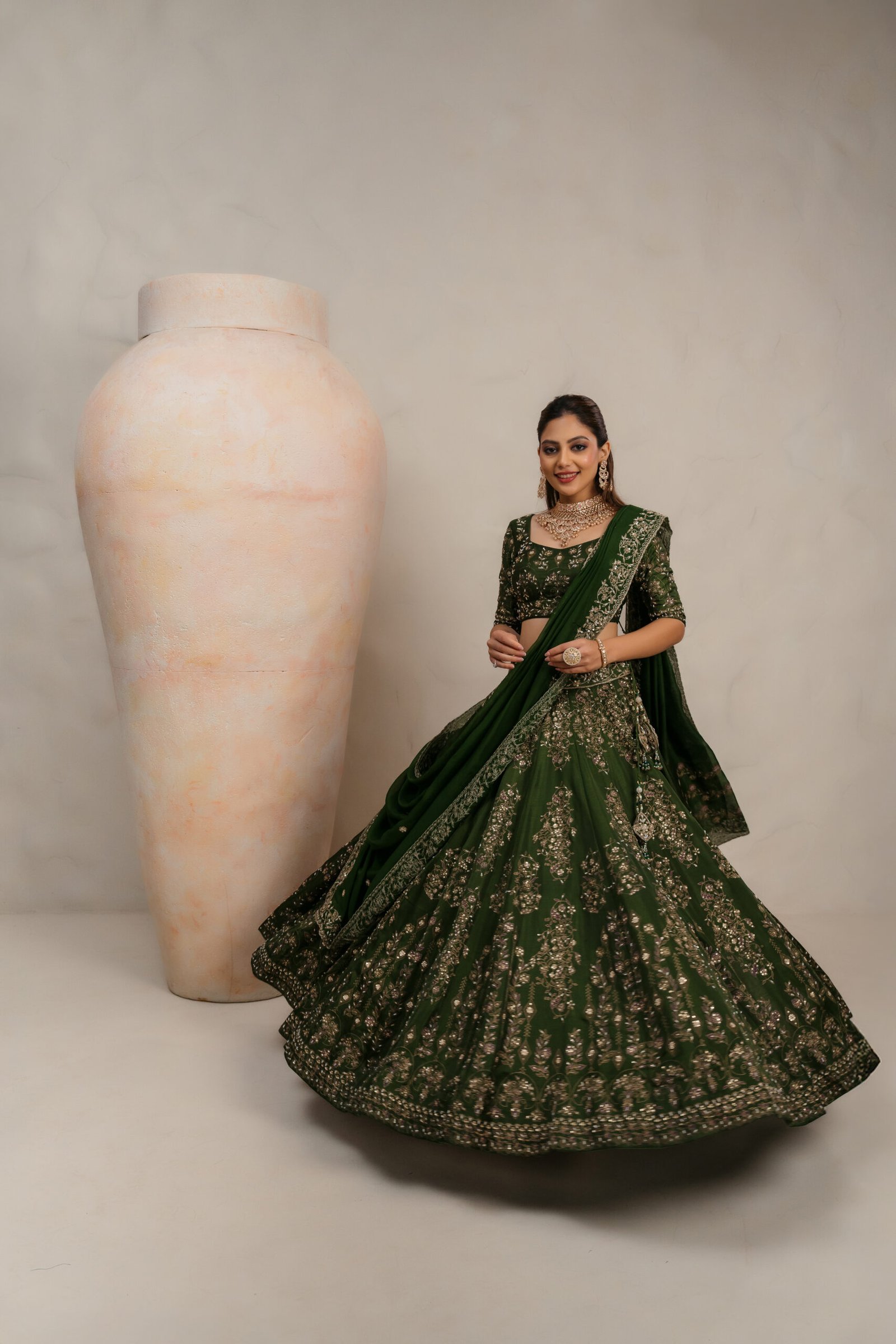 Dark green bridal lehenga choli with gold zari and sequin embroidery